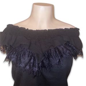 Black shirt with ruffles n mesh.